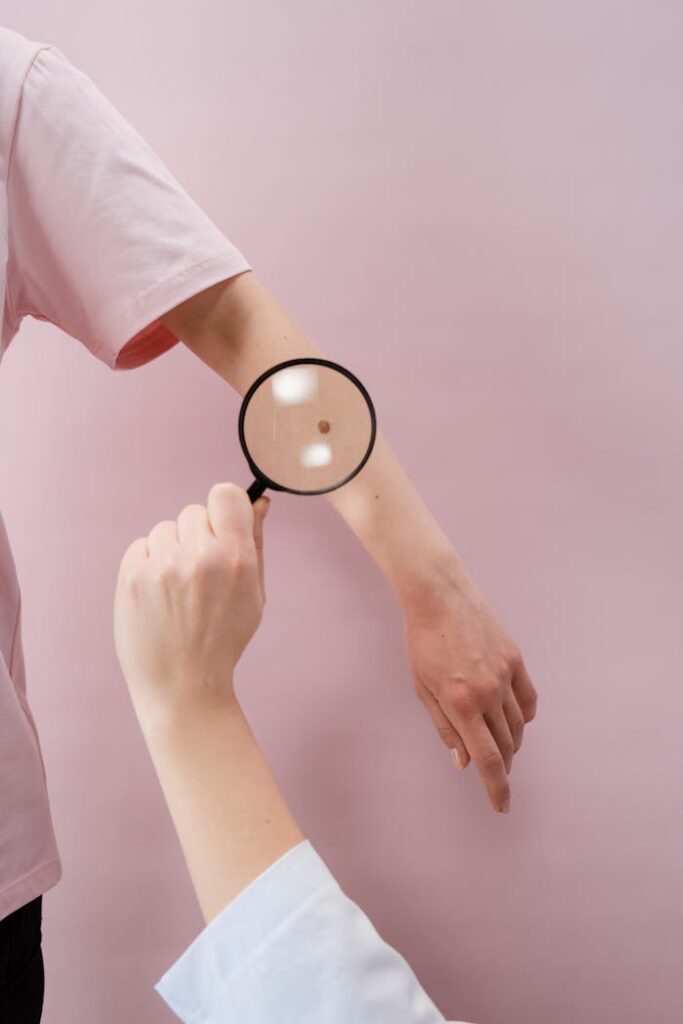 Person Holding Magnifying Glass With White Background